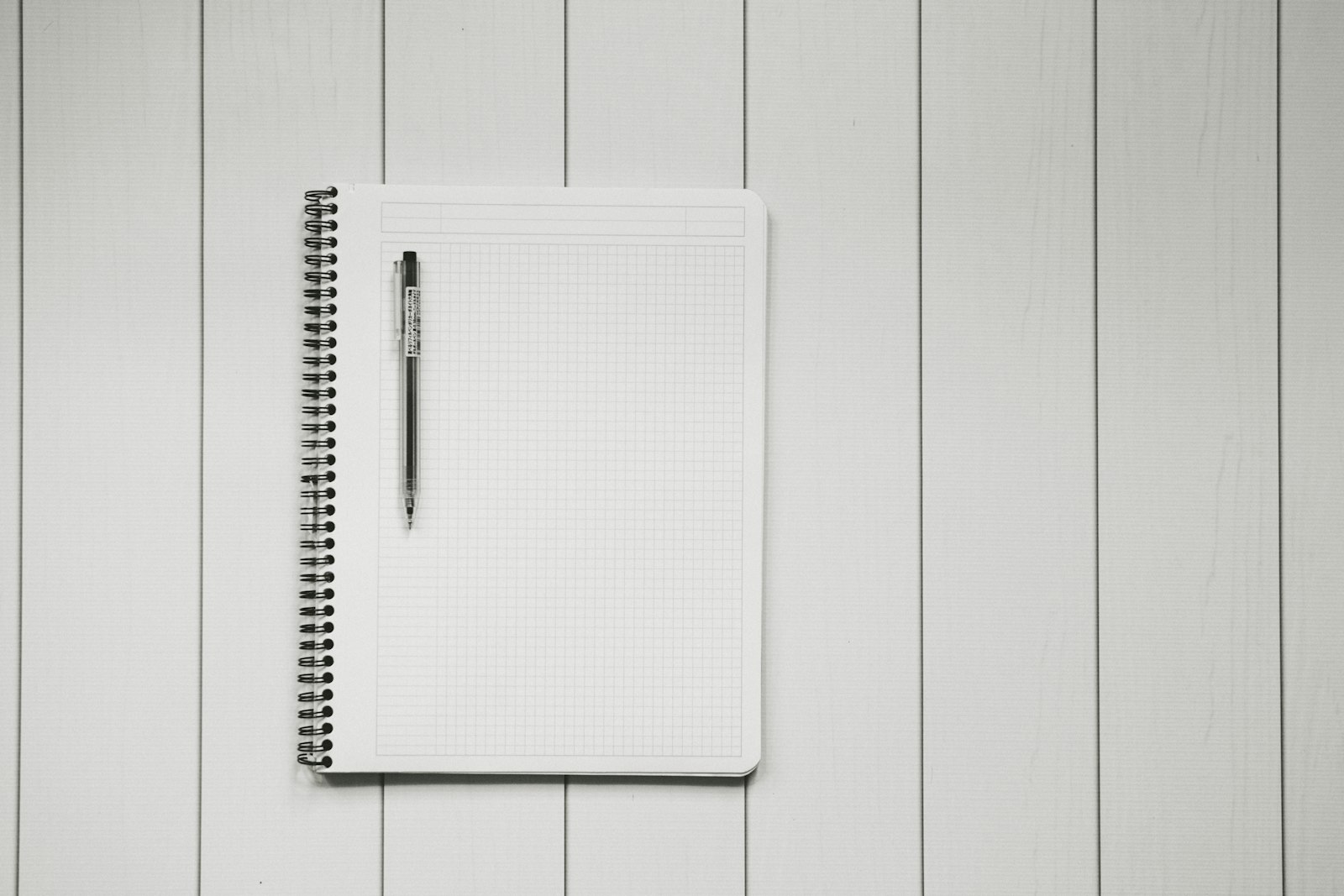 Grid notebook and pen on a desk